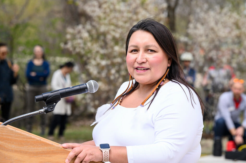 Photo: A woman speaks at a podium.