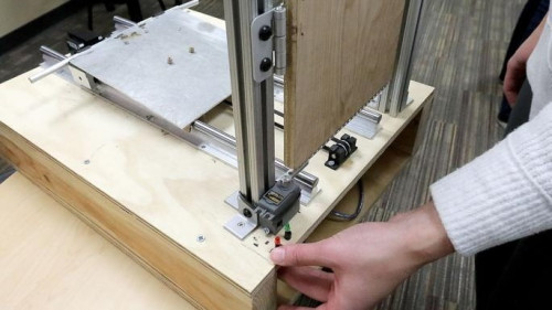 A tabletop model of an accessible boat ramp made from plywood and metal