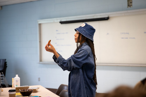 A person talks to a class of people.