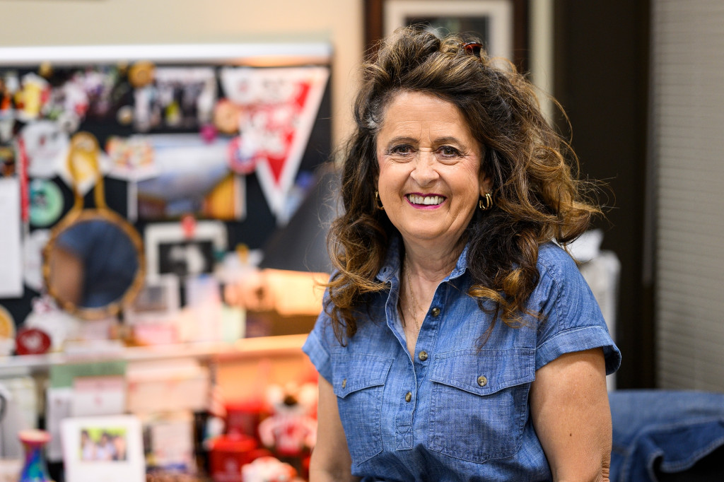 A woman smiles at the camera.