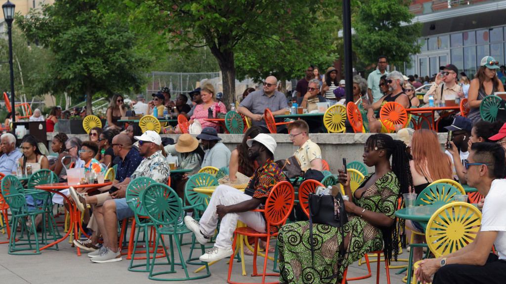 People seated on the Terrace clap after a performance.