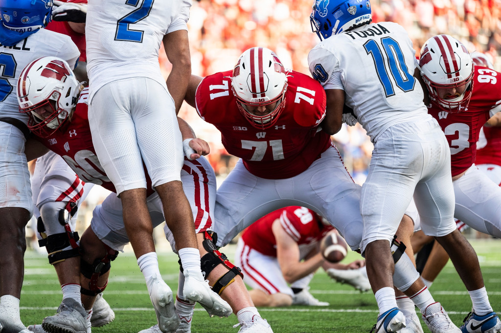 Linemen block the defensive linemen.