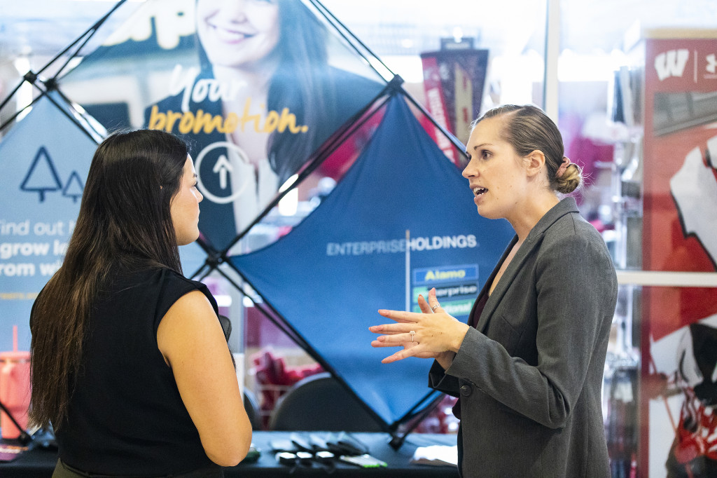 A woman talks to another woman.