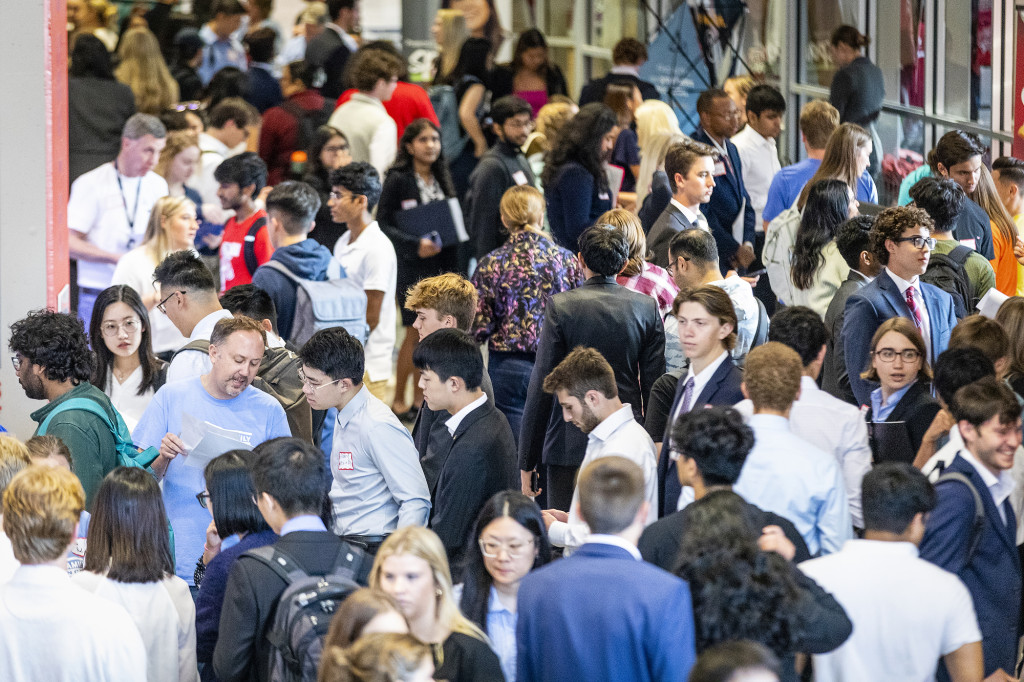 A crowd of young people fill a lobby.