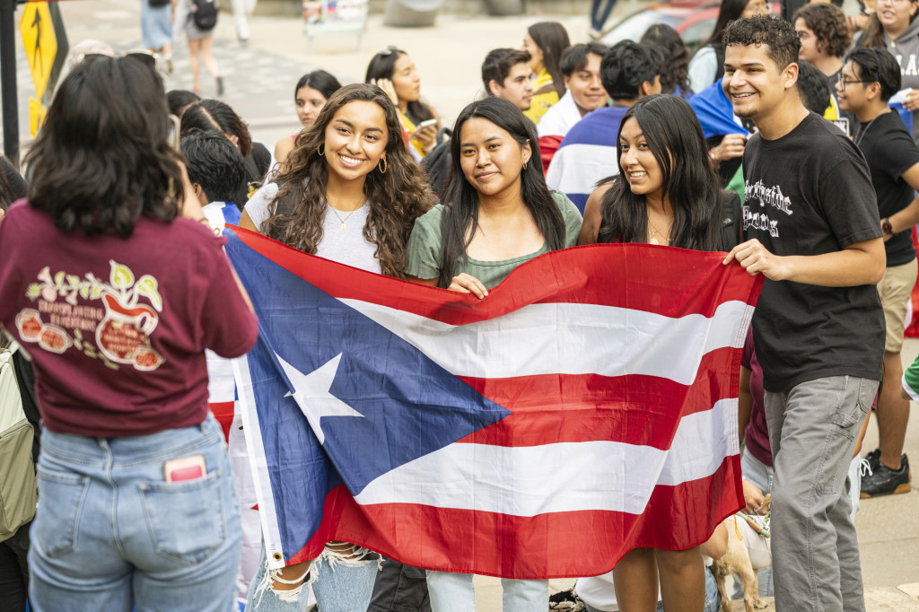 Some people hold up the Puerto Rican flag.