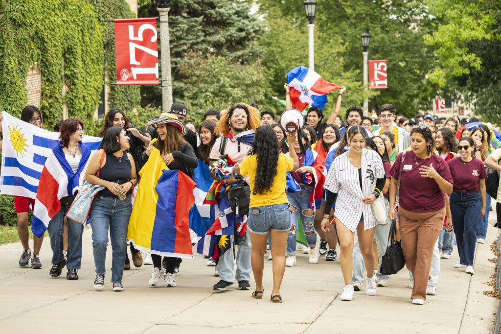 A group of people walk up Bascom Hill.