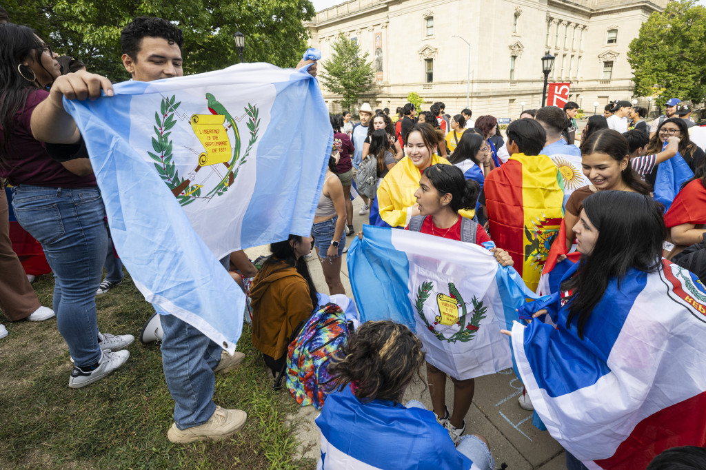 Students hand out flags.