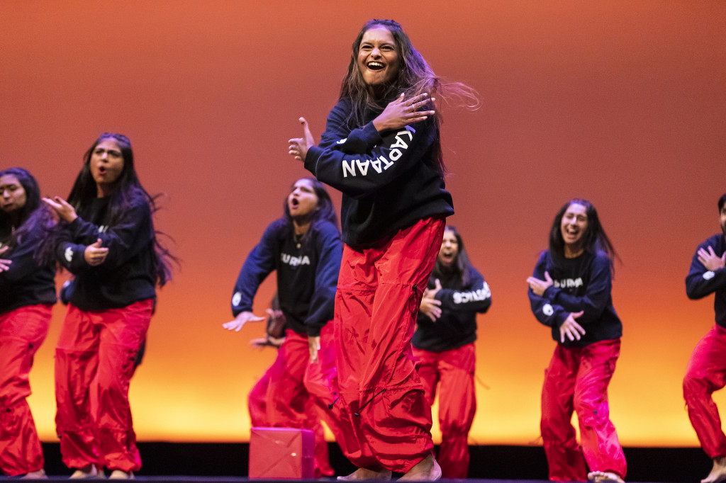 Several dancers perform on stage.