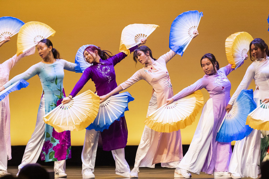 Students dance with fans.