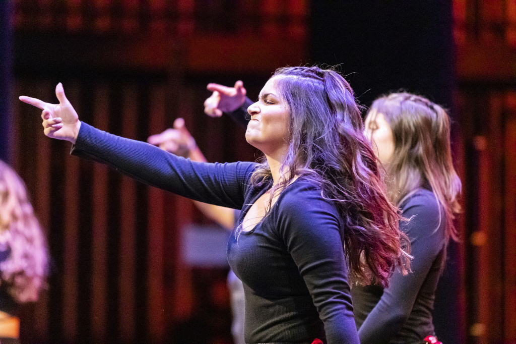 A woman gestures as she dances.