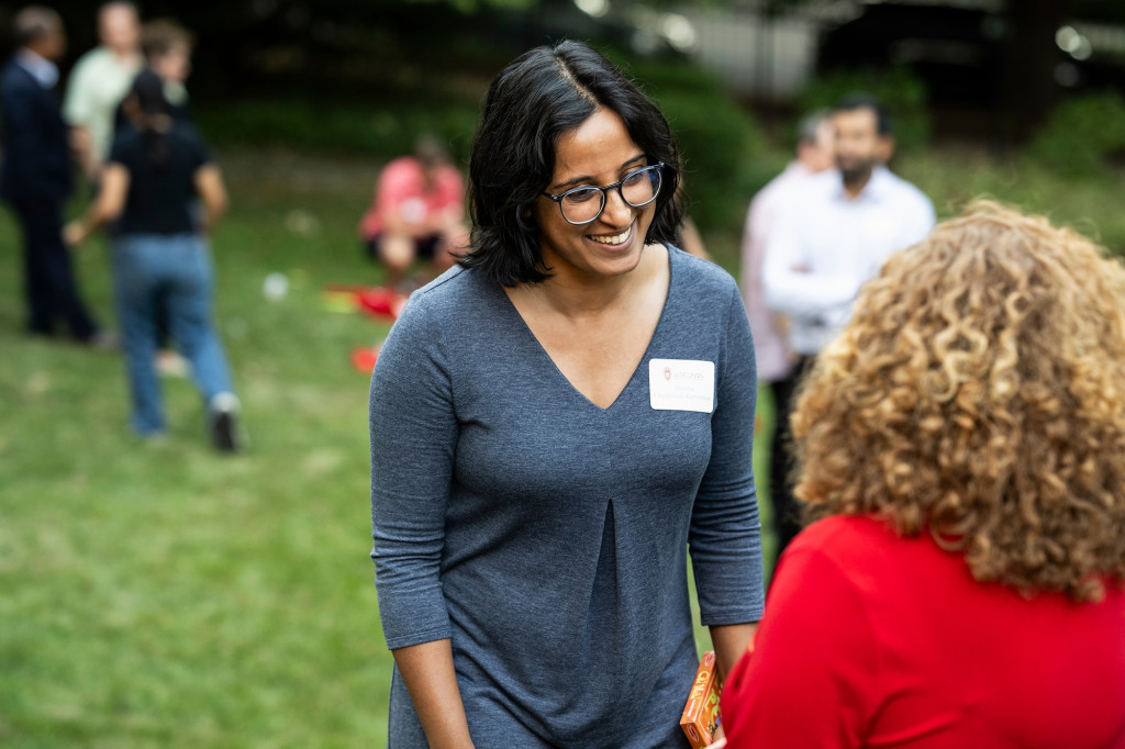 From behind, Chancellor Mnookin in coversation with a new faculty member.