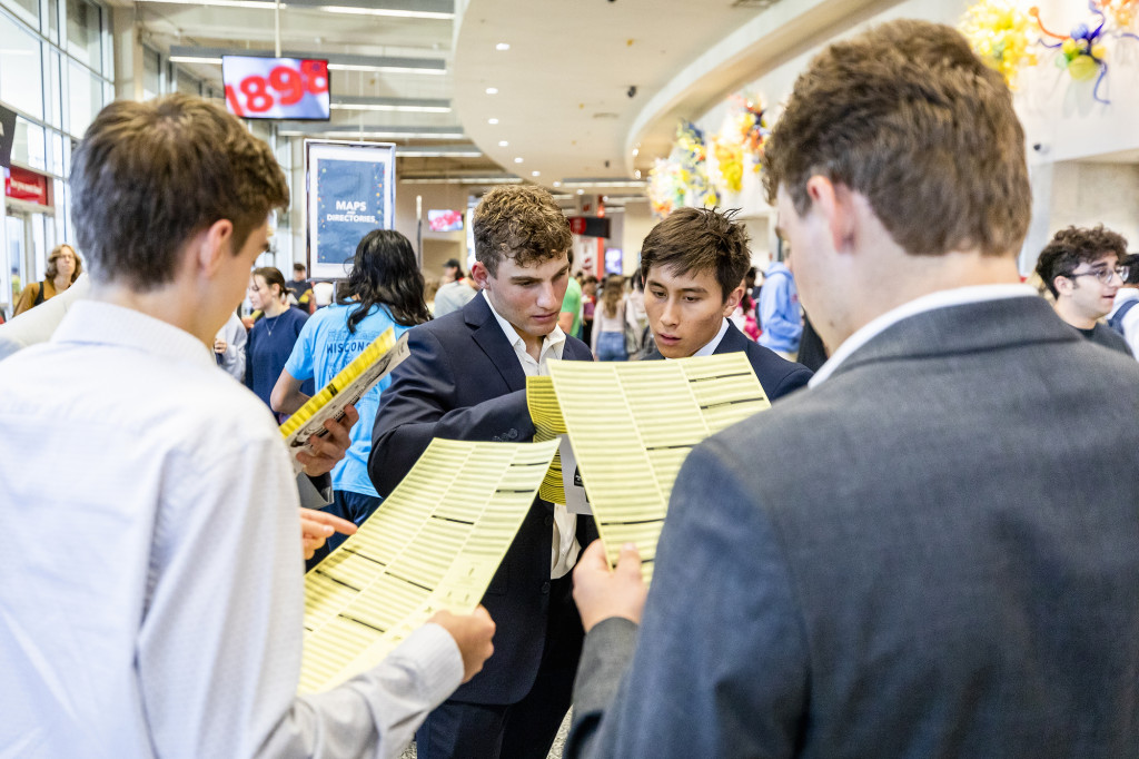 Students huddle around a map and talk.