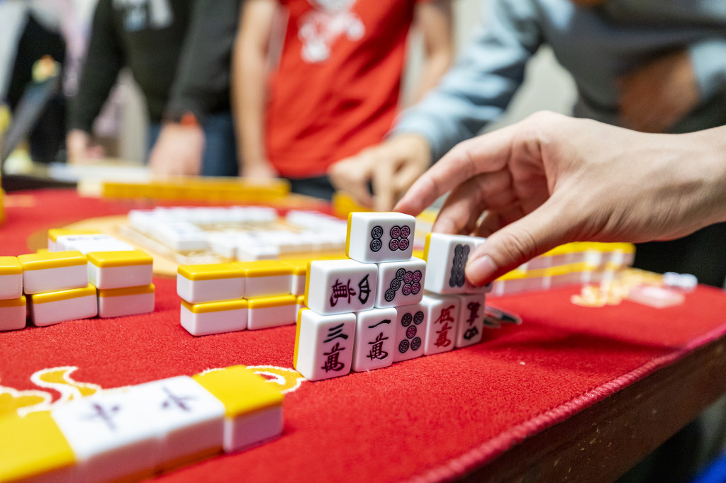 A person's hand moves blocks on a board.