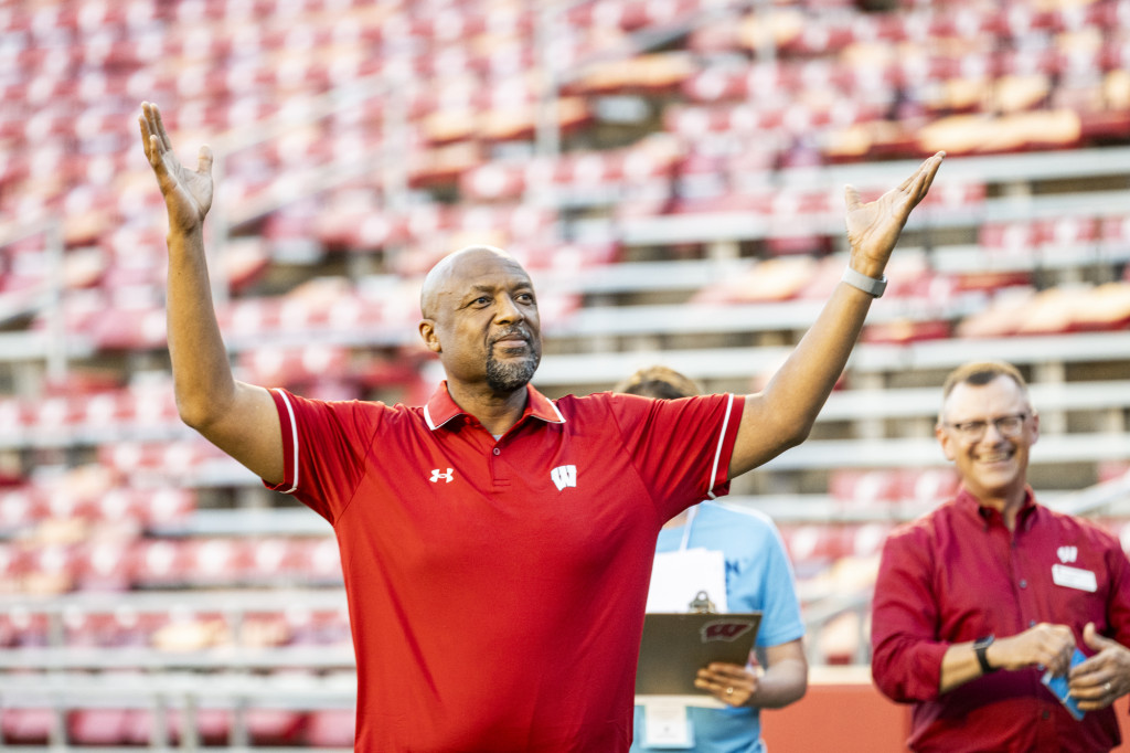 Provost Isbell raises his hands as if to signal for students to rise to their feet.