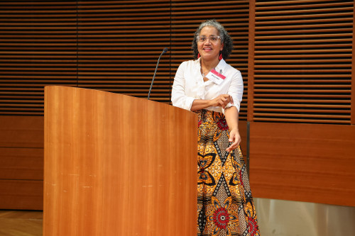 A woman speaks at a podium.