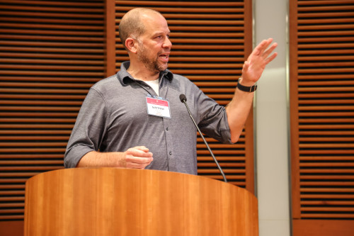 A man talks at a podium.