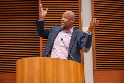 A man speaks at a podium.