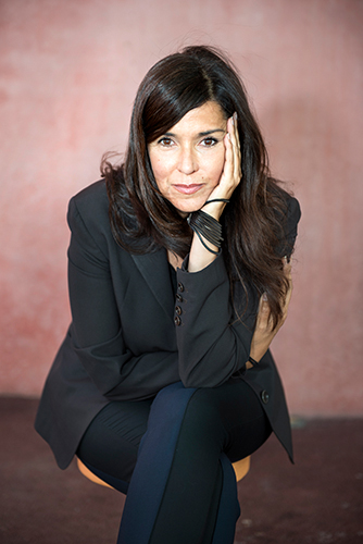 A woman sits for a photo portrait.