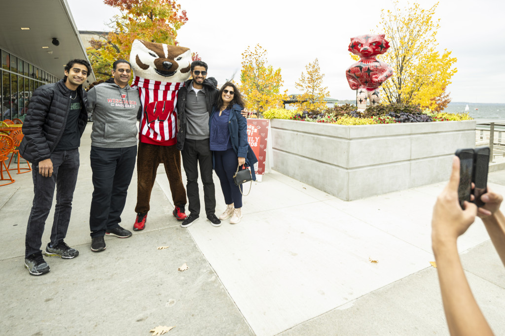 A family poses with Bucky Badger.