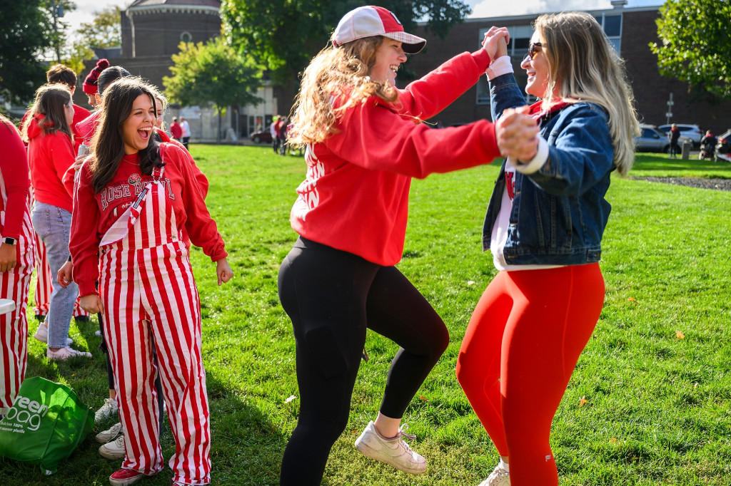 Two young women dance the polka on the lawn of a park in Madison.