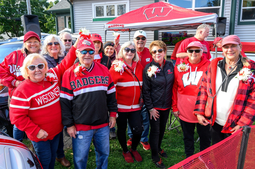 A group of Badger Fans pose with floral corsage.