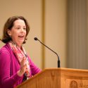 Diana Hess speaks at a podium.