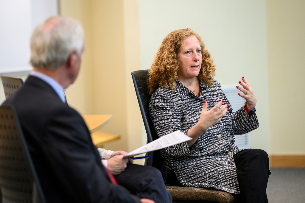 Two people gesture while talking.