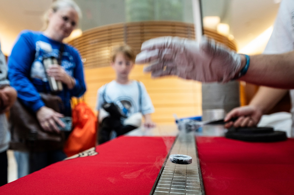 Kids watch as college students run an experiment.