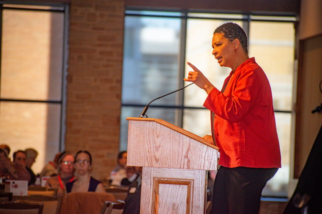 A woman speaks at a podium.