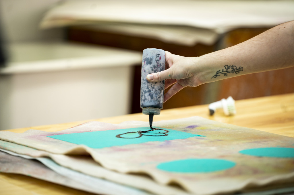 Flake demonstrates a paper-making process.