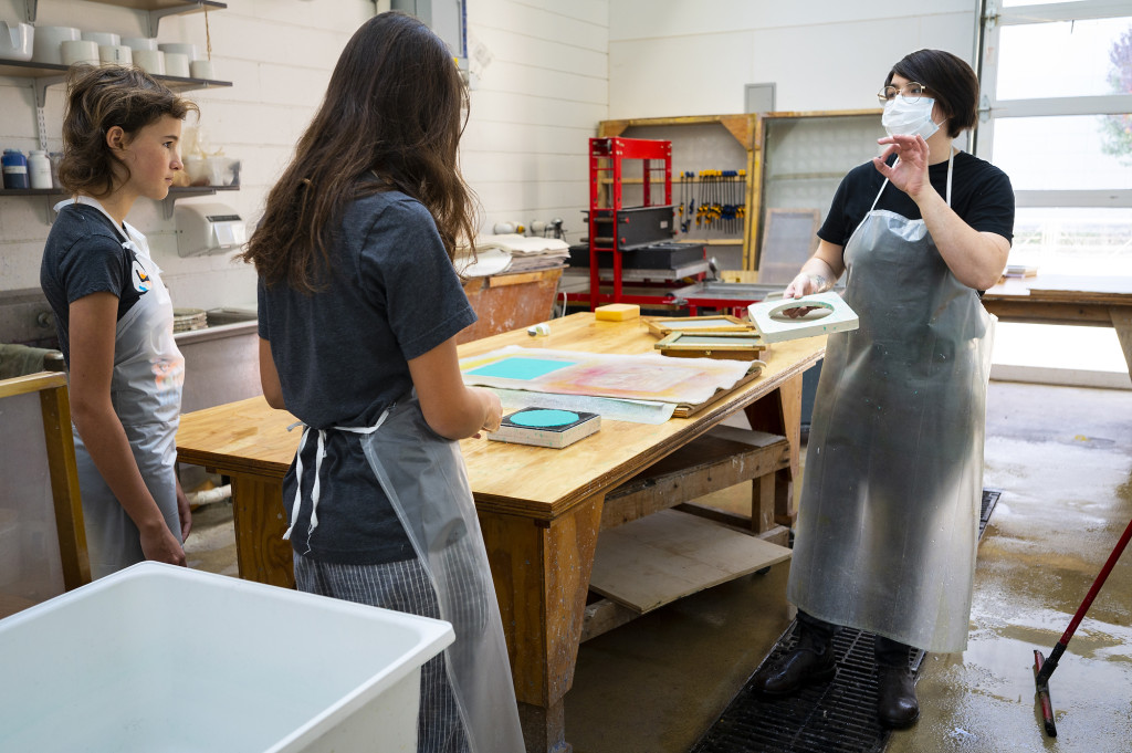 Several people work around a table.