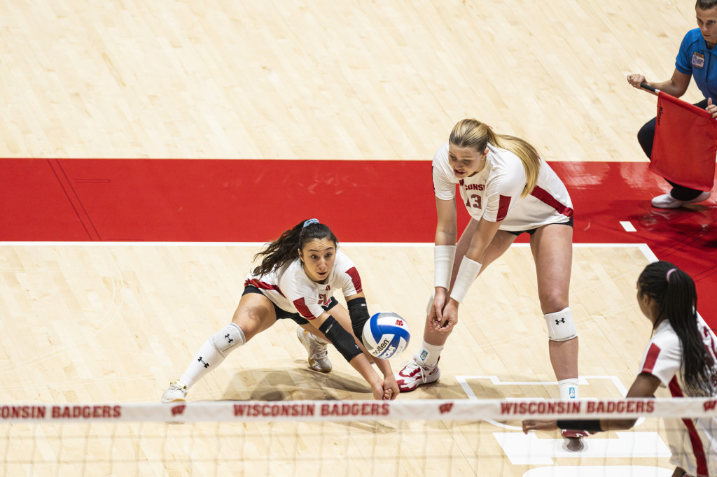 A player reaches down to bump the ball.