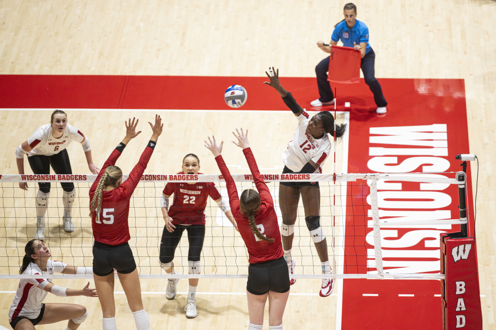 A player hits the ball over the net.