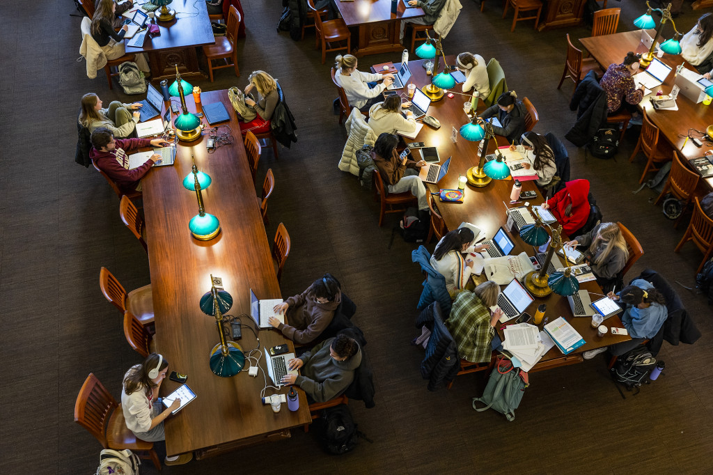 Students sit at two rows of desks lined up.