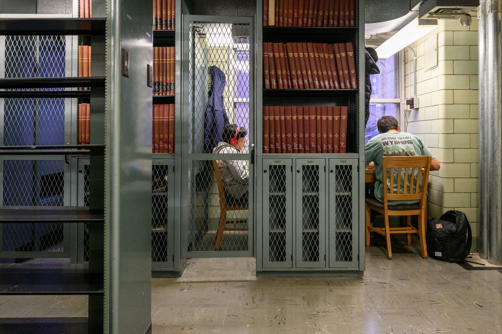 A student sits in a carrel studying.