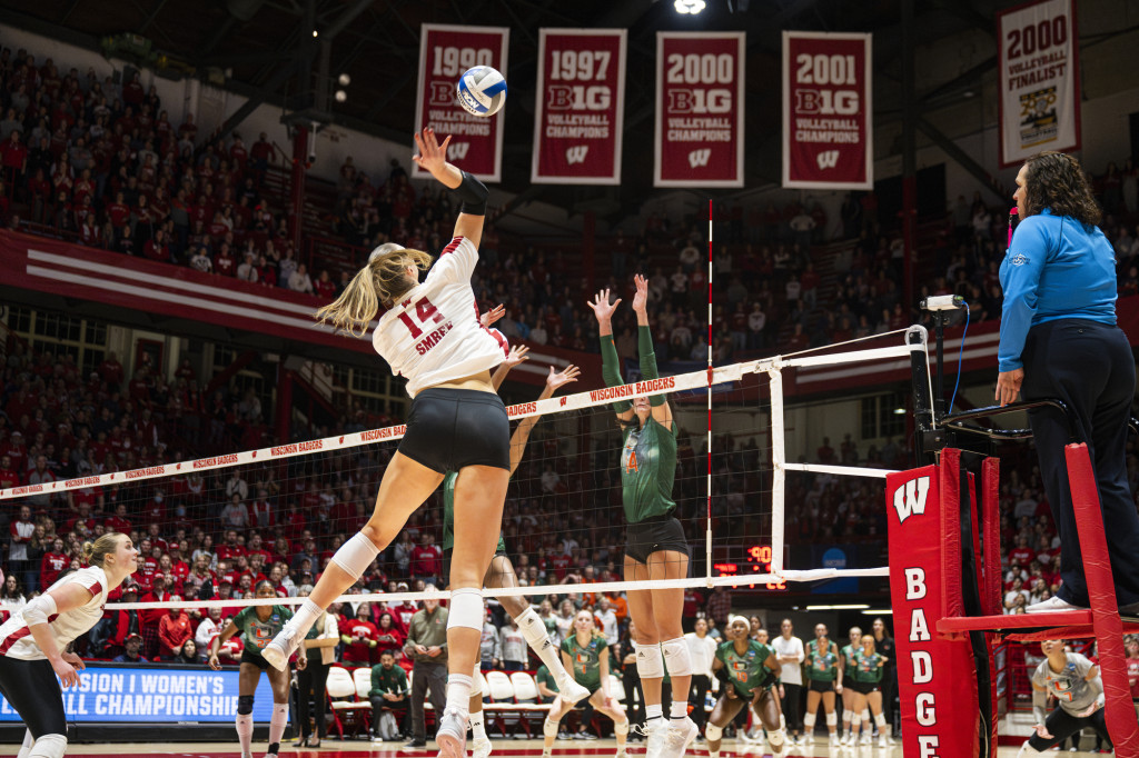 Anna Smrek (14) spikes the ball against Miami.