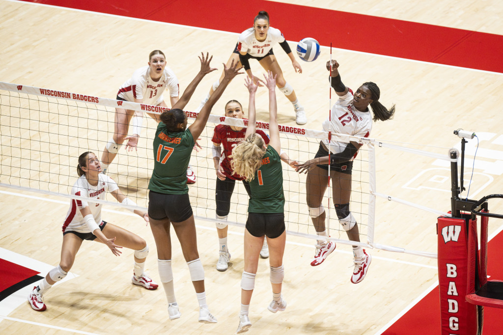 A woman hits a volleyball.