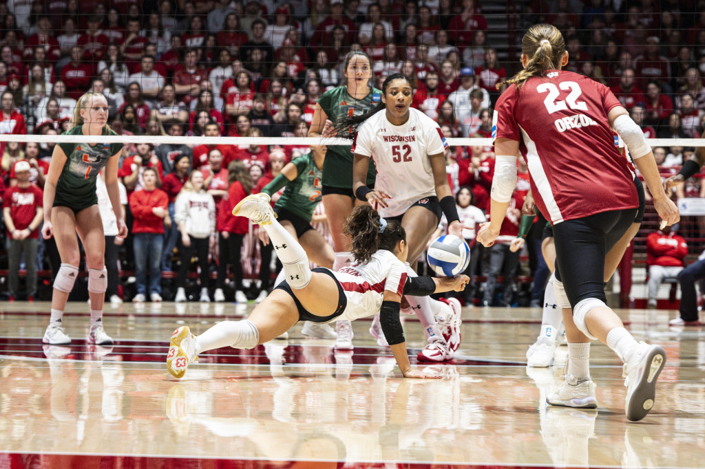 A woman hits a volleyball.