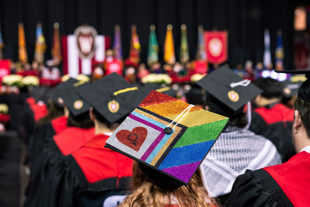 A woman wears an ornately decorated mortarboard.