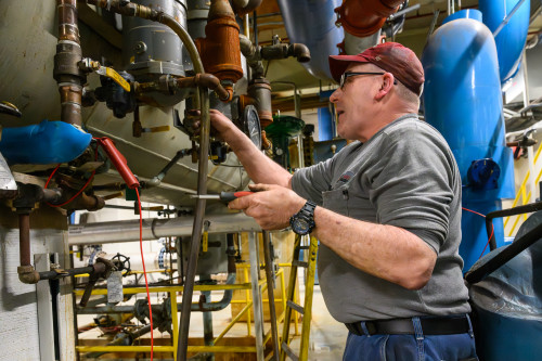 A man works with some pipes.