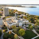 An aerial photo of the UW–Madison campus shows Bascom Hall in the foreground and Lake Mendota in the background.