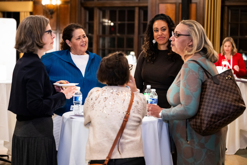 People talk around a table.