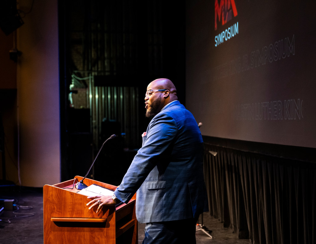 A man speaks at a podium.