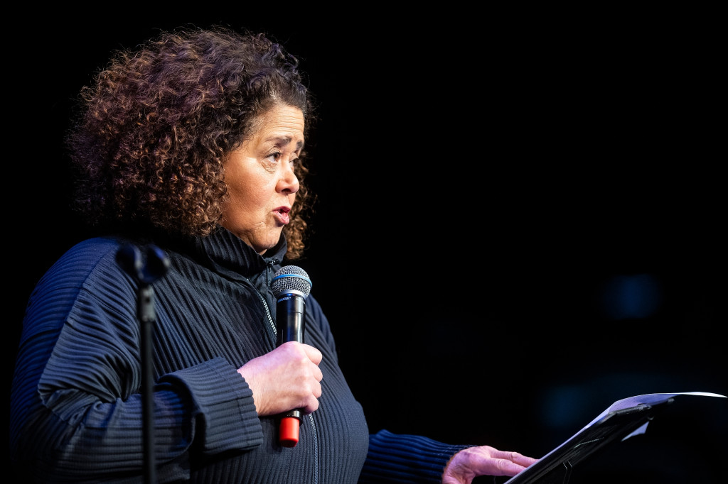 A woman speaks at a podium.