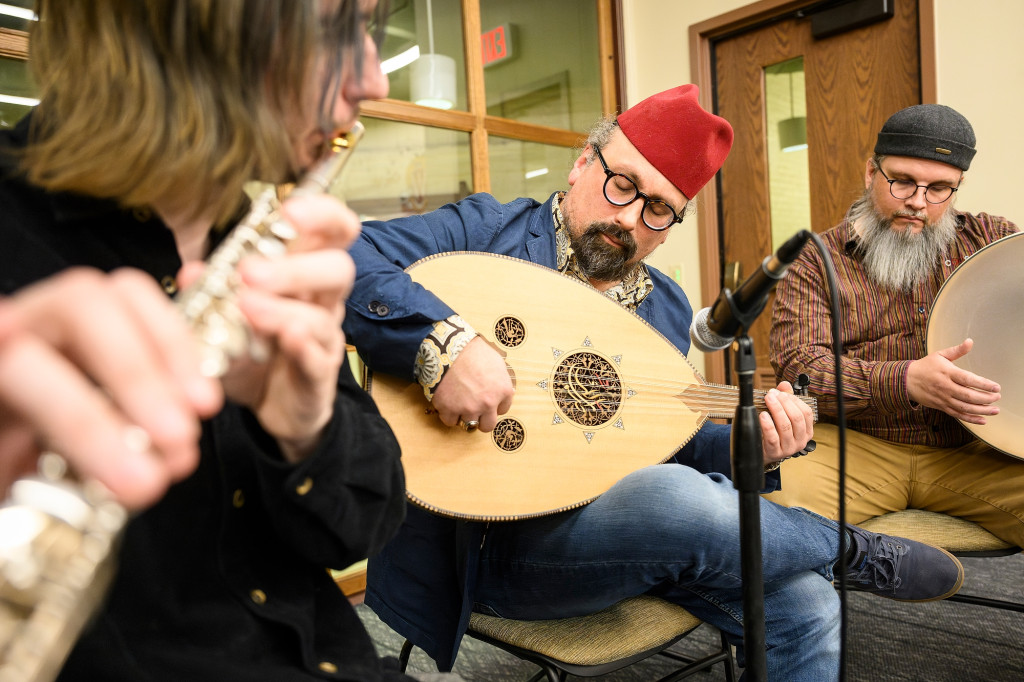 People play instruments and sing.