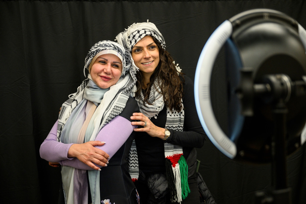 Two people pose in a photo booth.