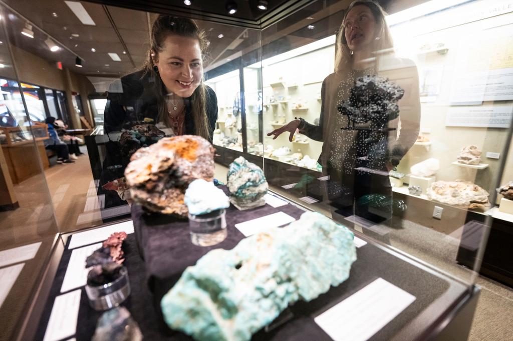 Two women look at rocks.