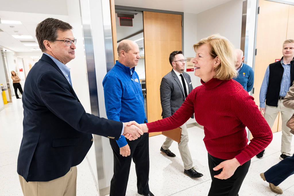 A man and a woman shake hands.