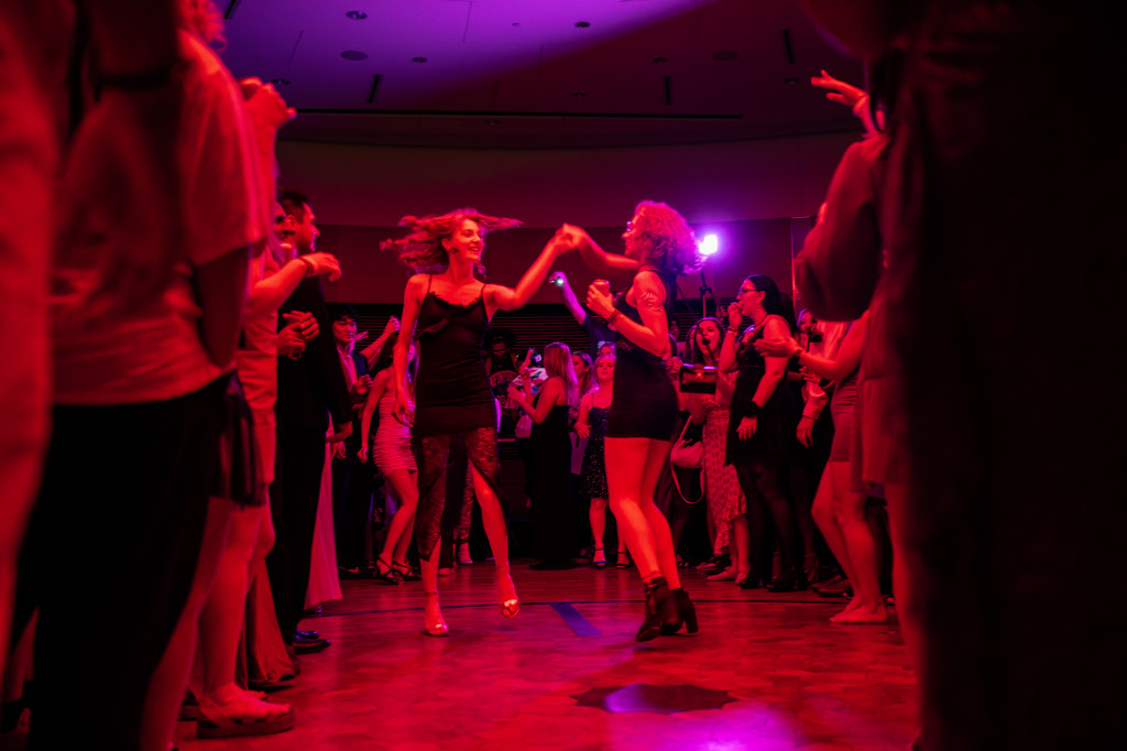 Two people dance on a dance floor.