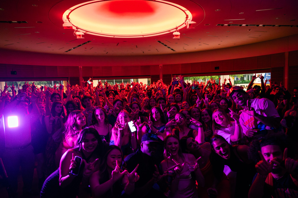 A group of people pose for a photo on a dance floor.